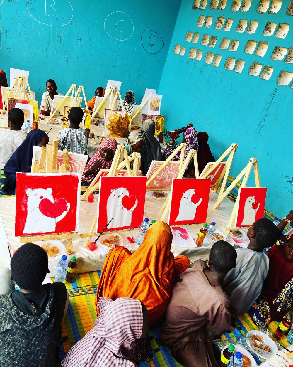Children take part in a creative art session with easels and paintings
