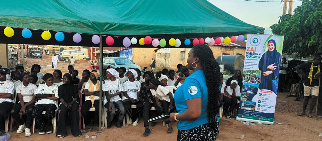Young people seated under a canopy at a ZAIDF session on financial literacy