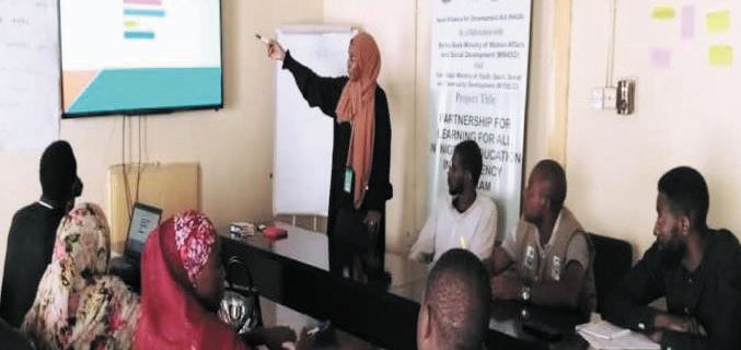 A trainer presents to ZAIDF staff in a meeting room