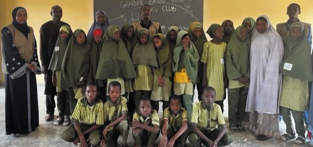 Students and teachers pose for a photo at a school GBV club