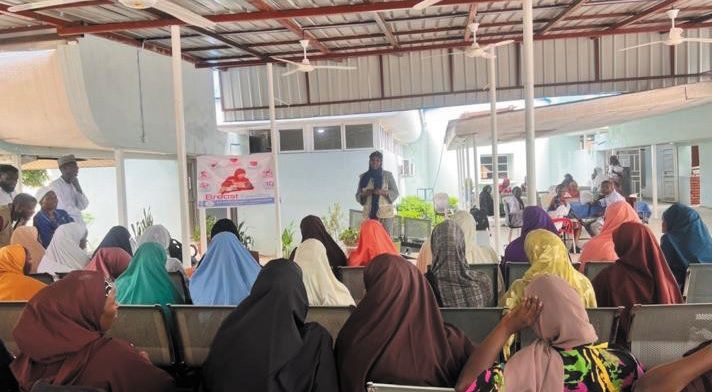 Mothers seated in a hospital waiting area during a breastfeeding education session