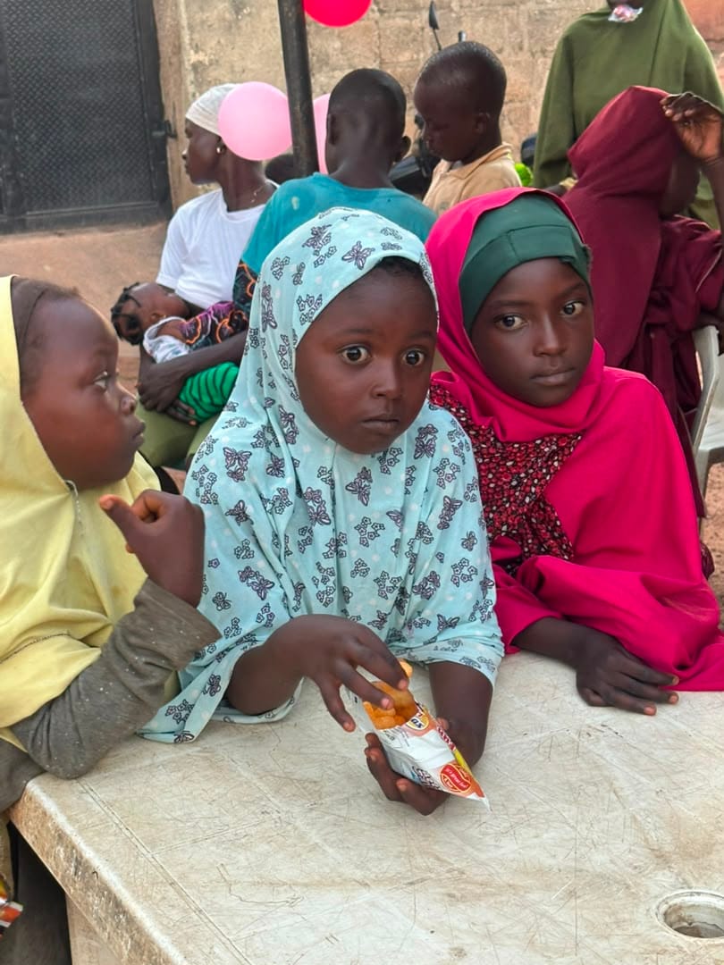 Two girls in headscarves listen during the menstrual hygiene session