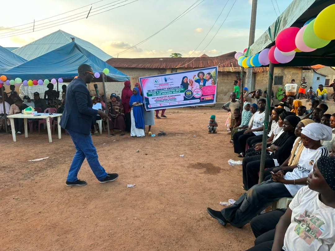 A facilitator moves through the venue as a seated audience listens